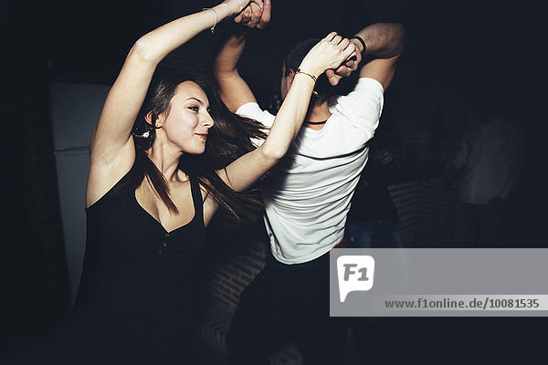 Happy couple dancing in nightclub