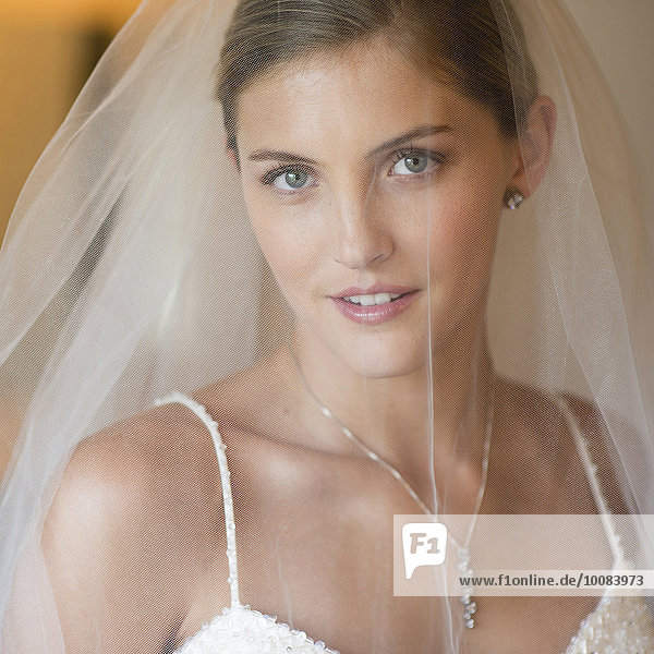 Caucasian bride wearing wedding gown and veil