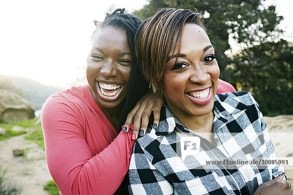 Smiling women hugging outdoors