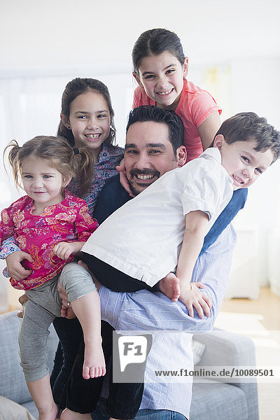 Caucasian father and children relaxing in living room