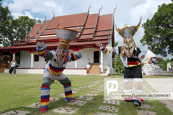 People dressed up with ghost masks and colourful costumes  Phi Ta Khon Masks Festival  near Wat Phon Chai  Amphoe Dan Sai  Loei province  Thailand  Asia