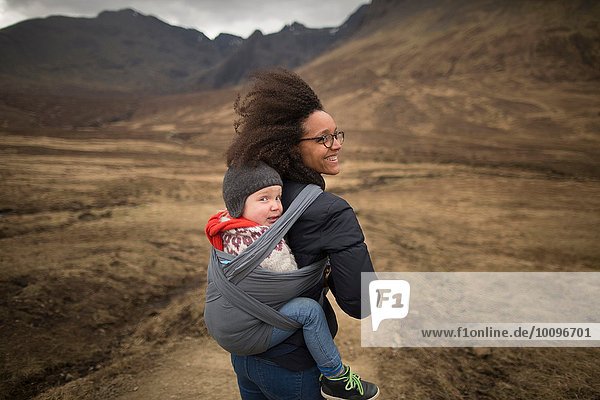 Mother carrying son in sling  Fairy Pools  near Glenbrittle  Isle of Skye  Hebrides  Scotland