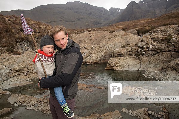 Father holding son  Fairy Pools  Isle of Skye  Hebrides  Scotland