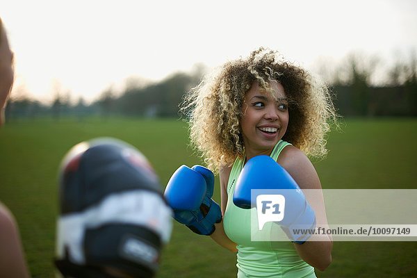 Zwei Frauen beim Training mit Boxhandschuhen im Park