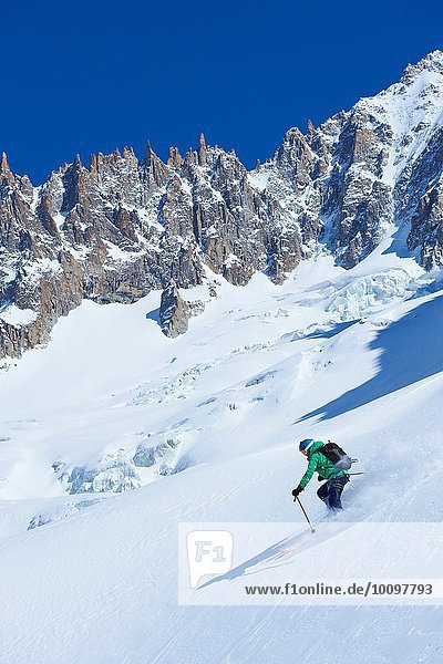Male skier skiing steep downhill on Mont Blanc massif  Graian Alps  France