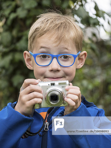 Boy with compact camera