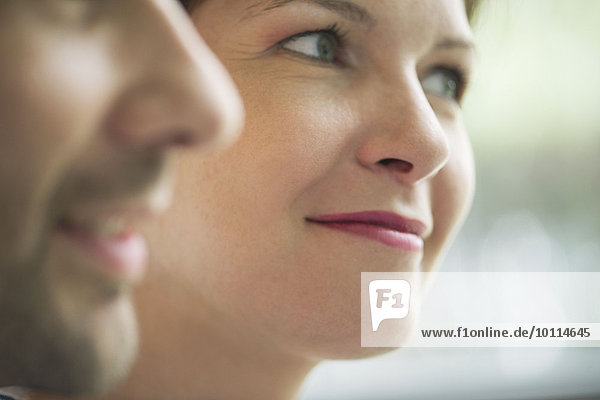 Close-up of couple smiling  focus on woman