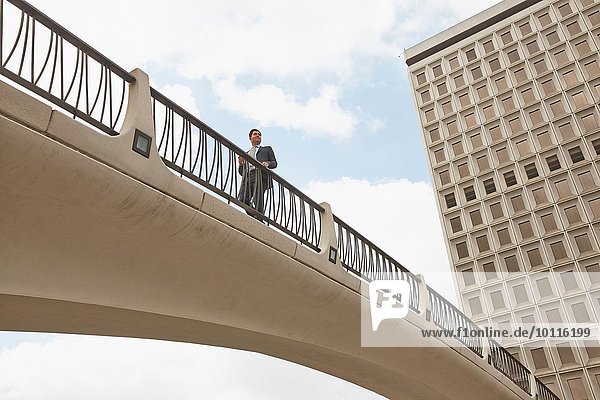 Low angle view of person on footbridge  City Hall East  Los Angeles  California  USA