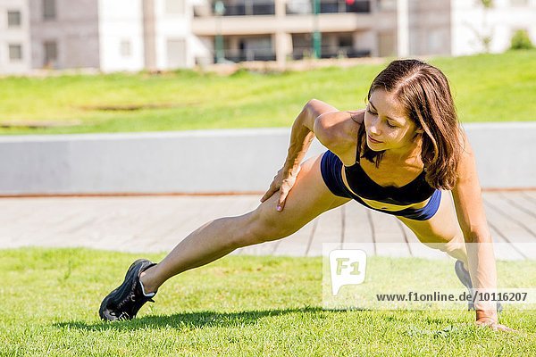 Young woman exercising in park