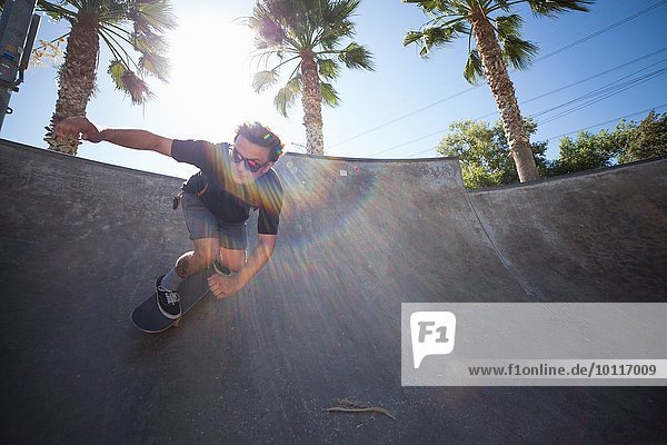 Young man skateboarding in park  Eastvale  California  USA