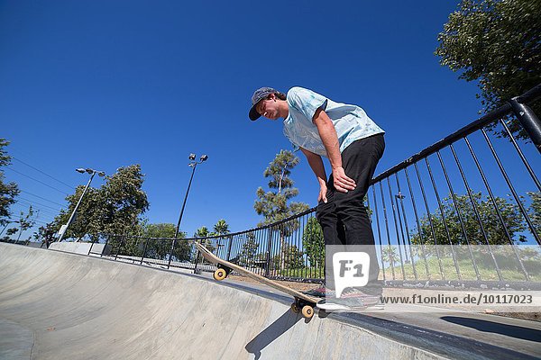 Young man skateboarding in park  Eastvale  California  USA