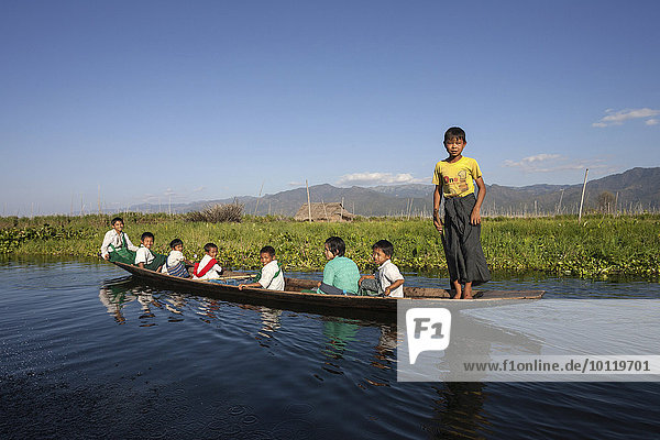 Local children in a wooden boat on Inle Lake  Shan State  Myanmar  Asia