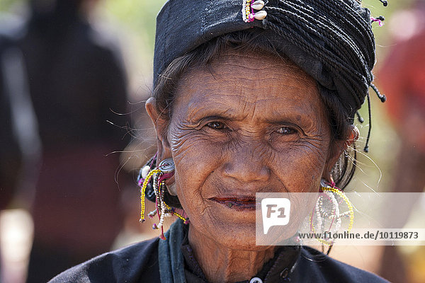 Native woman in typical clothing and headgear from the Ann tribe in a mountain village at Pin Tauk  portrait  Shan State Golden Triangle  Myanmar  Asia