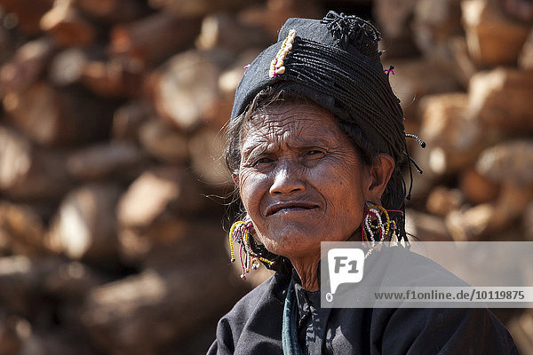 Native woman in typical clothing and headgear from the Ann tribe in a mountain village at Pin Tauk  portrait  Shan State Golden Triangle  Myanmar  Asia