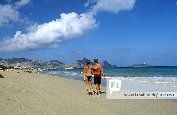 Couple walking along a sandy beach on Porto Santo Island  Madeira  Portugal  Europe