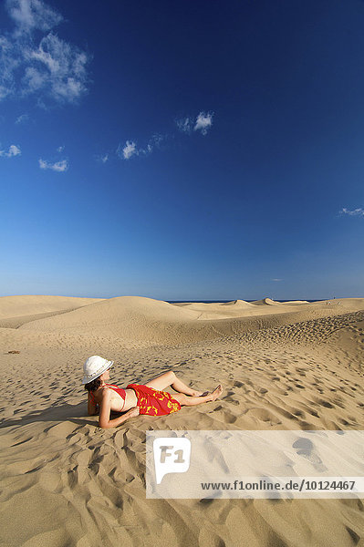 Woman in front of sand dunes of Maspalomas  Gran Canaria  Canary Islands  Spain  Europe