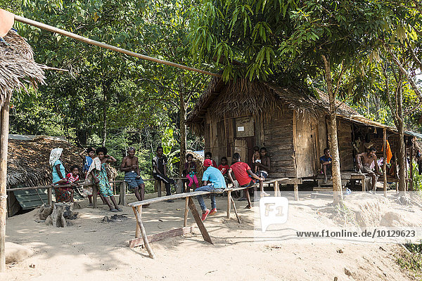 People sitting in front of wooden huts  Orang Asil tribe  aboriginal  indigenous people  Taman Negara National Park  Malaysia  Asia