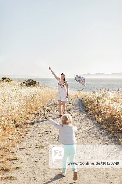 Mother and daughter playing kite