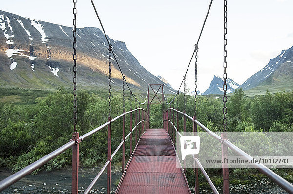 Hanging footbridge in mountains