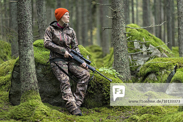 Woman hunting in forest