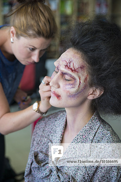 Schauspielerin wird von Maskenbildnerin als Zombie geschminkt für die Zombiekomödie Brain Freeze