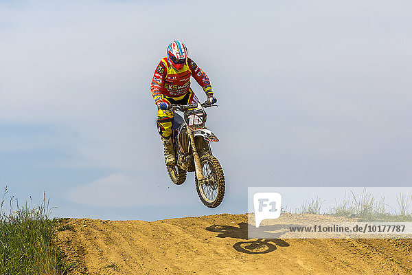 Motocross  jumping over a mound  Oberrieden  Bavaria  Germany  Europe