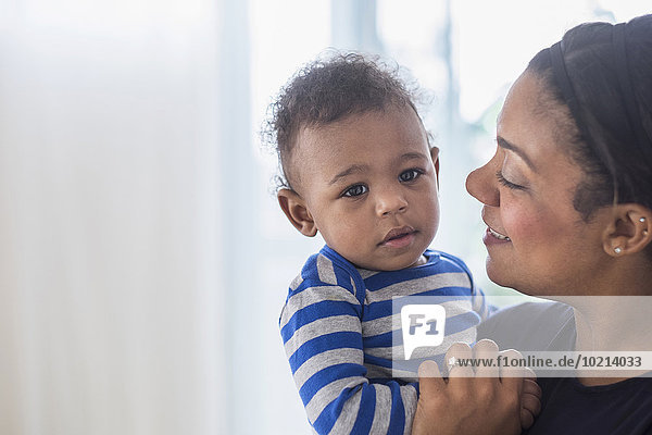 Close up of mixed race mother holding baby son