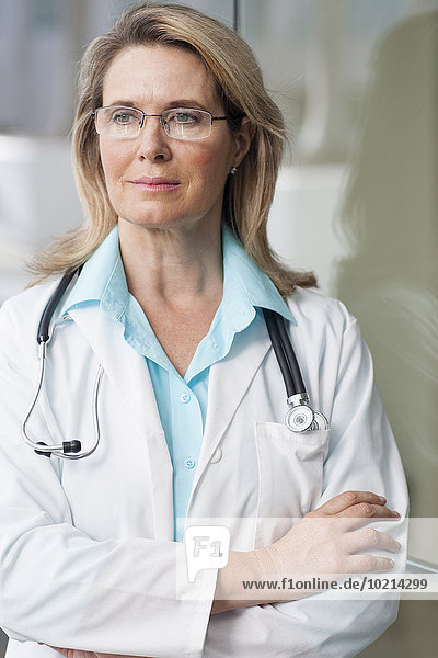Caucasian doctor standing with arms crossed