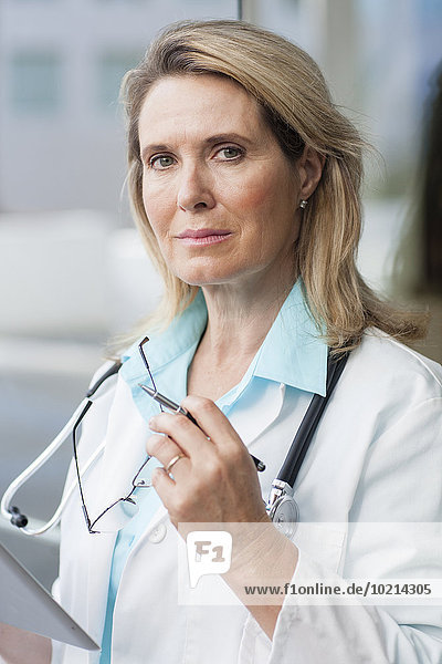 Close up of Caucasian doctor using digital tablet