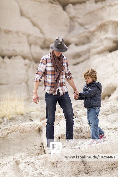 Father and son exploring desert rock formations