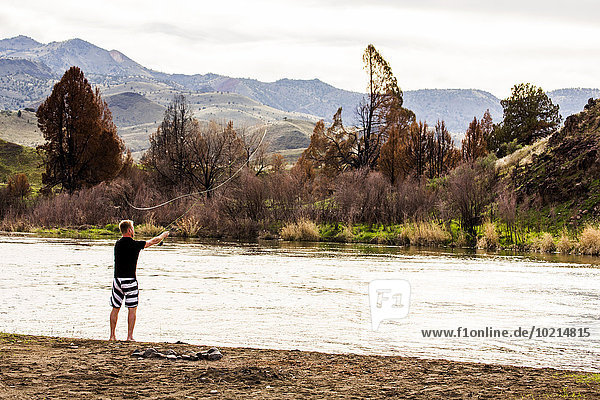 Caucasian man fishing in remote river  Painted Hills  Oregon  United States