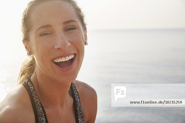 Close up of woman laughing on beach