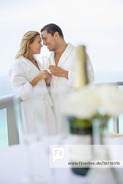 Couple drinking champagne on balcony table