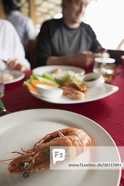 Close up of plate of shrimp on restaurant table