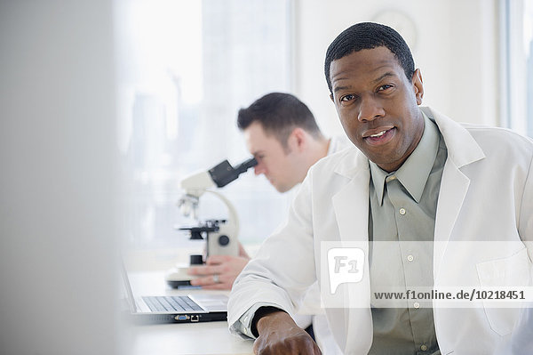 Scientist sitting at table in lab