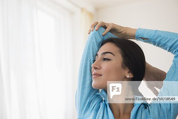 Close up of woman stretching arm
