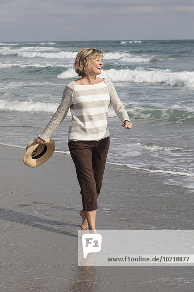 Caucasian woman walking on beach