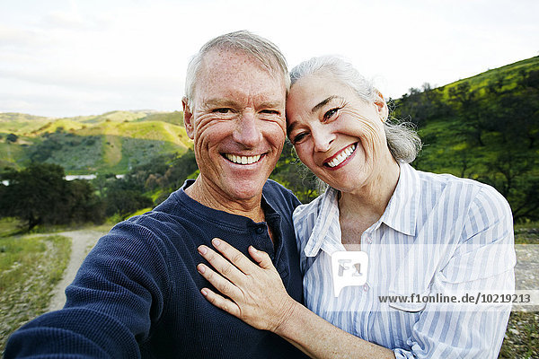 Caucasian couple standing on hiking trail