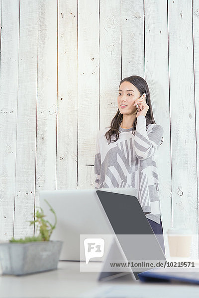 Young Japanese woman working in a stylish office