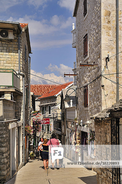 Croatia  Primosten  People walking in narrow lane in old town