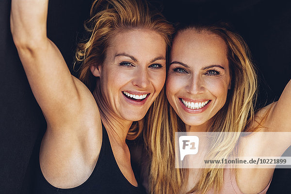 Portrait of two smiling blond women