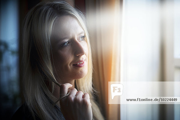 Portrait of blond woman telephoning with smartphone