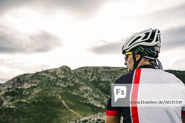Spain  Tarragona  Mountain biker in extreme terrain  looking at landscape