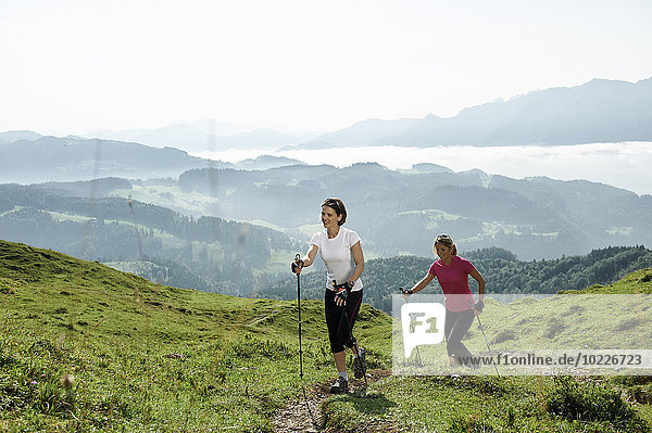 Austria,  Two women Nordic walking at Kranzhorn