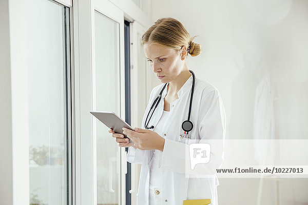 Female doctor using digital tablet