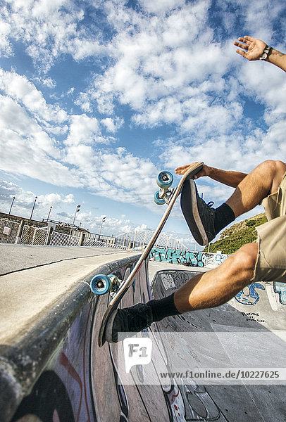 Legs of young man skateboarding in a skatepark