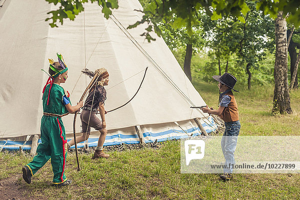 Germany  Saxony  Indians and cowboy party  Boys playing with bow and arrow