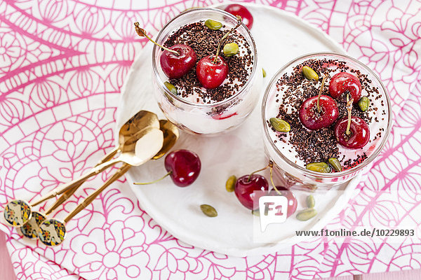 Glass of yoghurt dessert with cherries