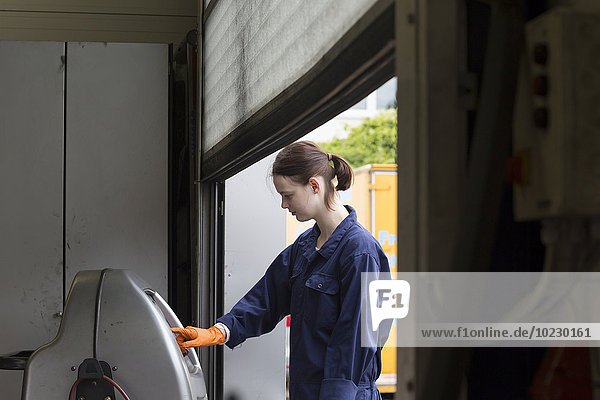 Young woman working in repair garage