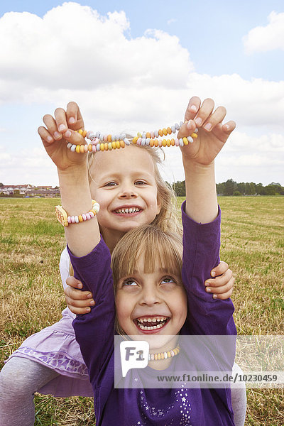 Two little girls with necklace and bracelet made of Hundreds and Thousands